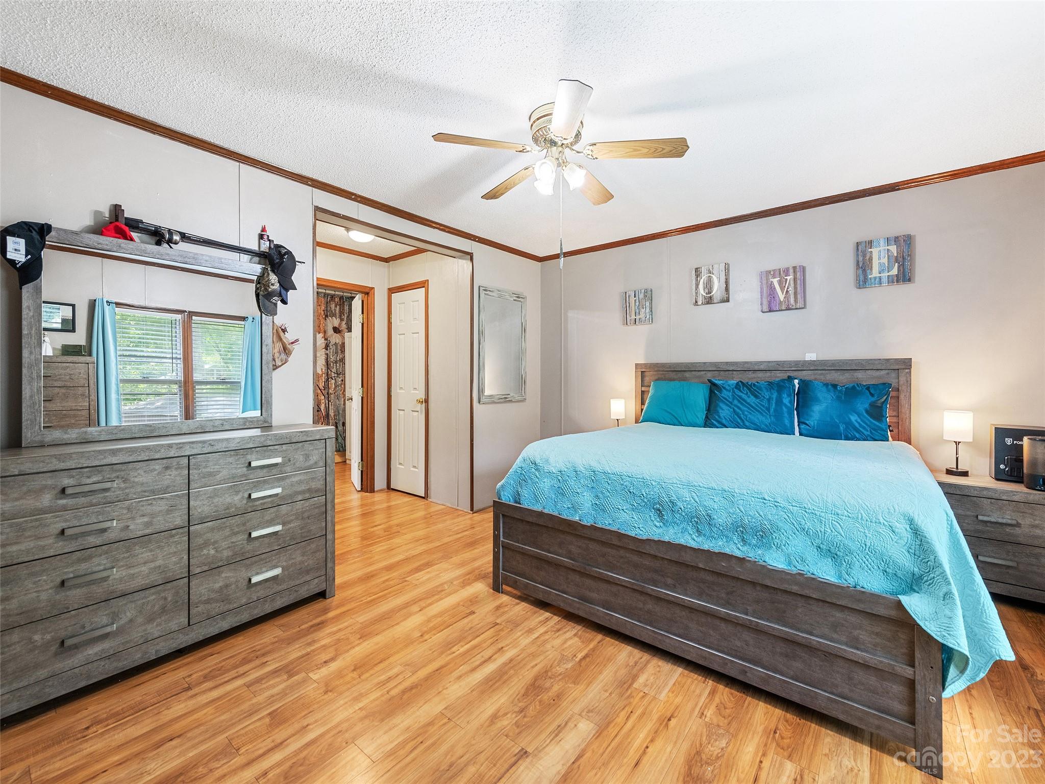 38 Happy Acres Road Waynesville, NC 28785 - Photo 21 of 28 a bedroom with a bed and a chandelier