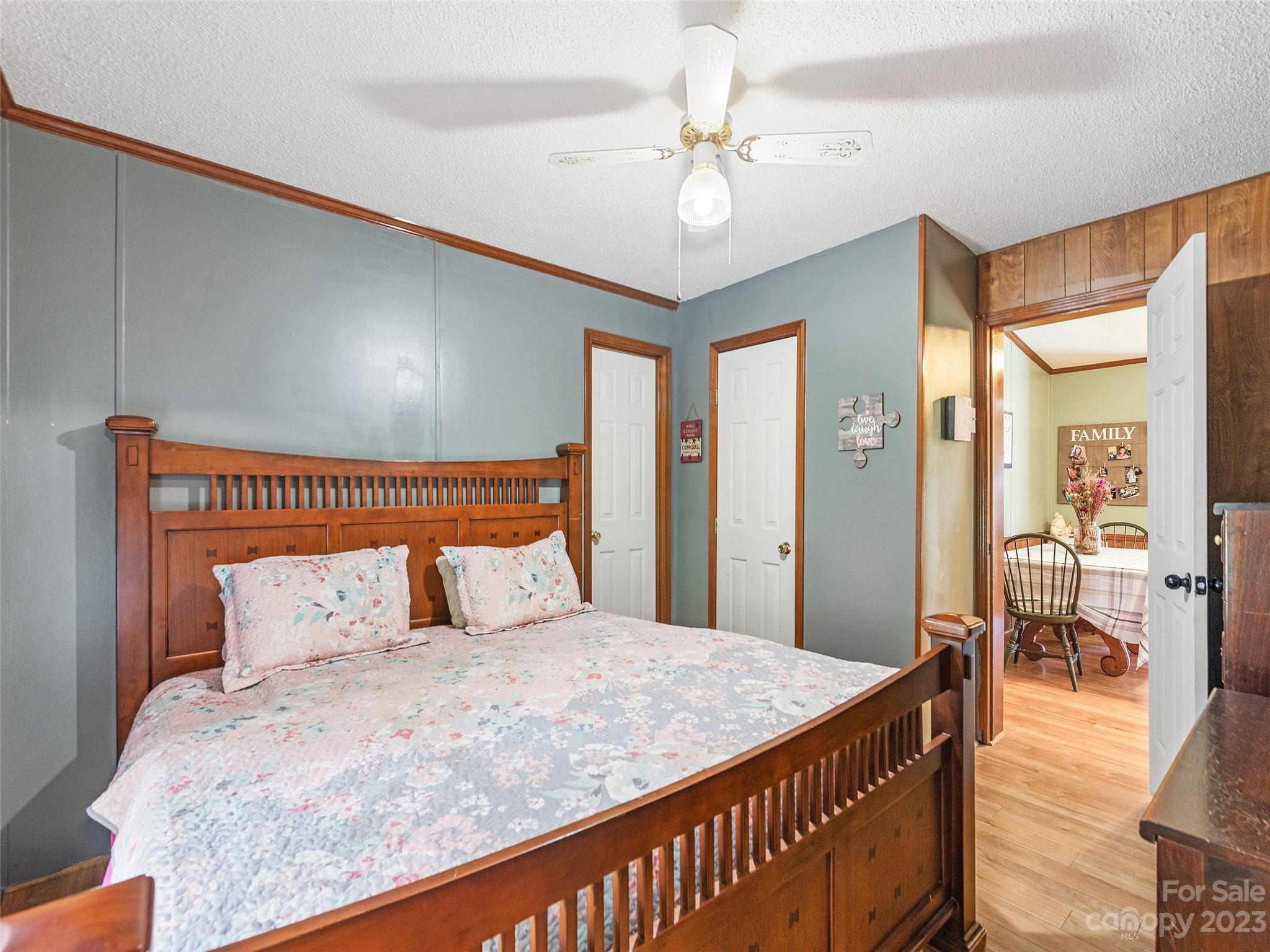 38 Happy Acres Road Waynesville, NC 28785 - Photo 23 of 28 a bedroom with a large bed and a chandelier