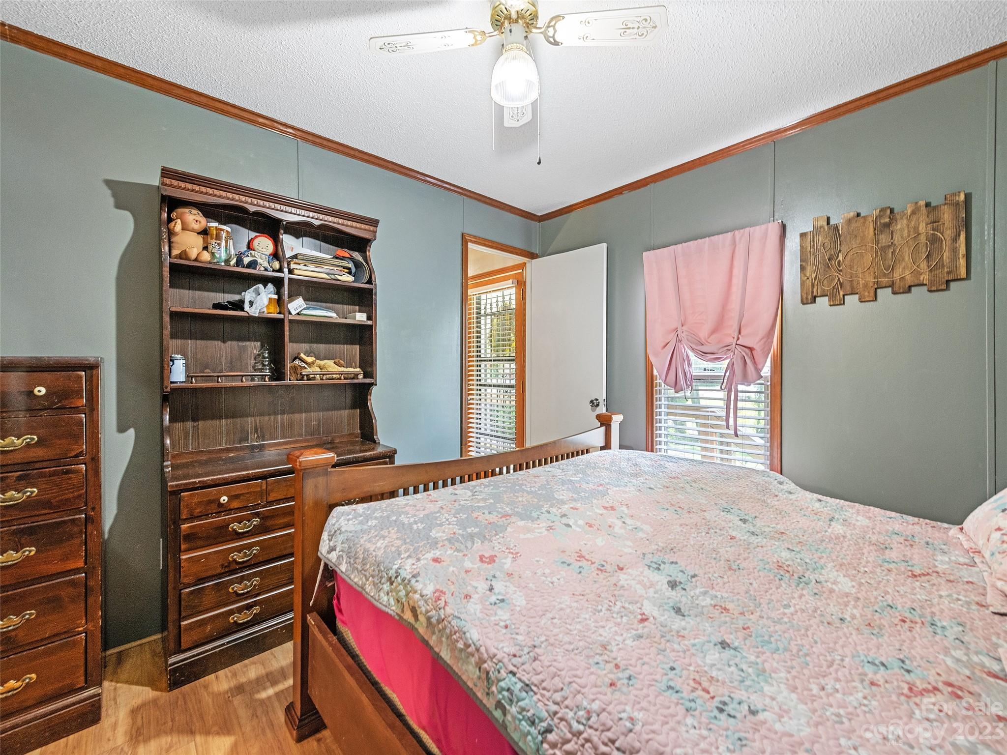 38 Happy Acres Road Waynesville, NC 28785 - Photo 24 of 28 a bedroom with a bed and a chandelier