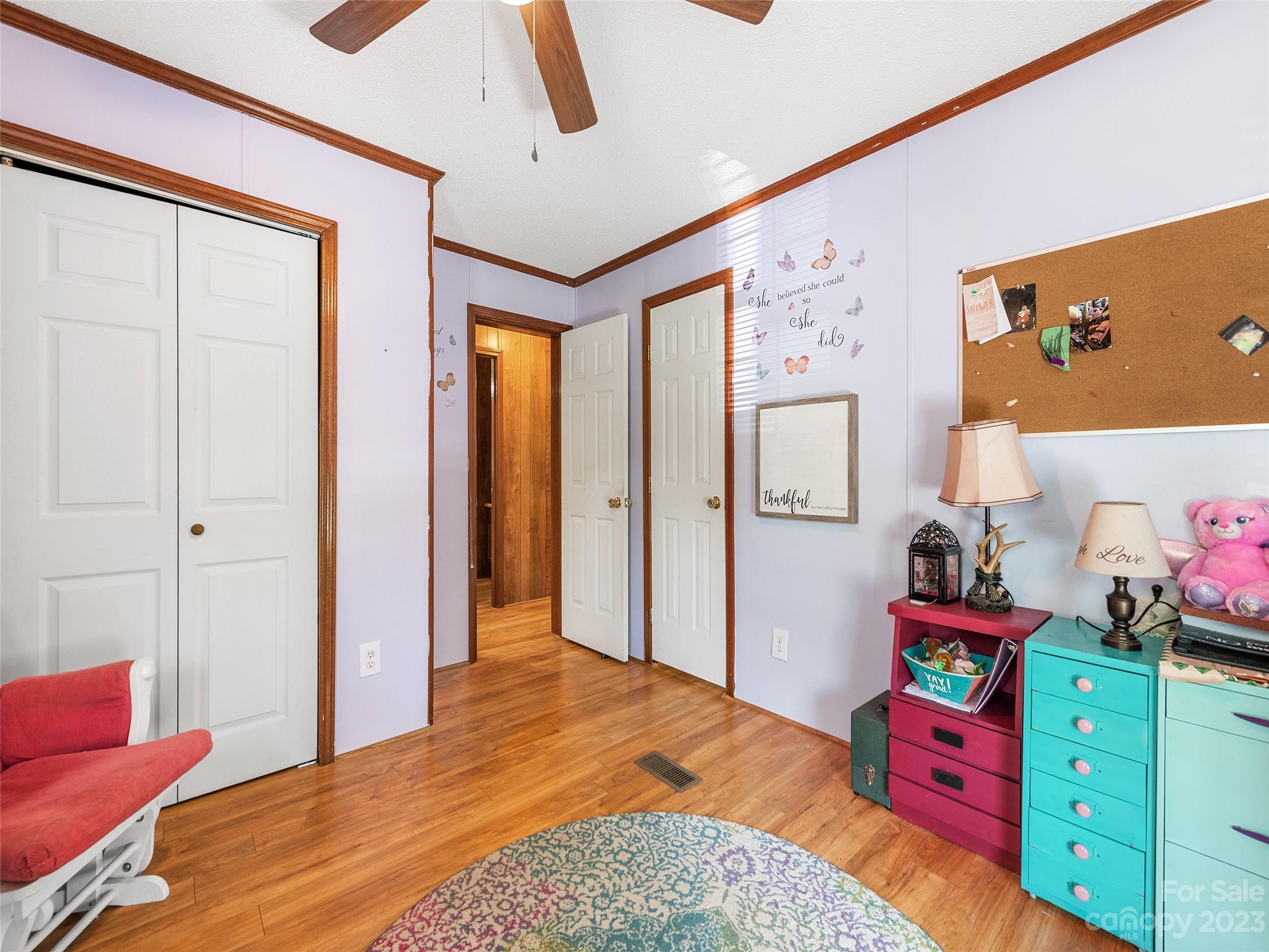 38 Happy Acres Road Waynesville, NC 28785 - Photo 26 of 28 a bedroom with a bed and wooden floor