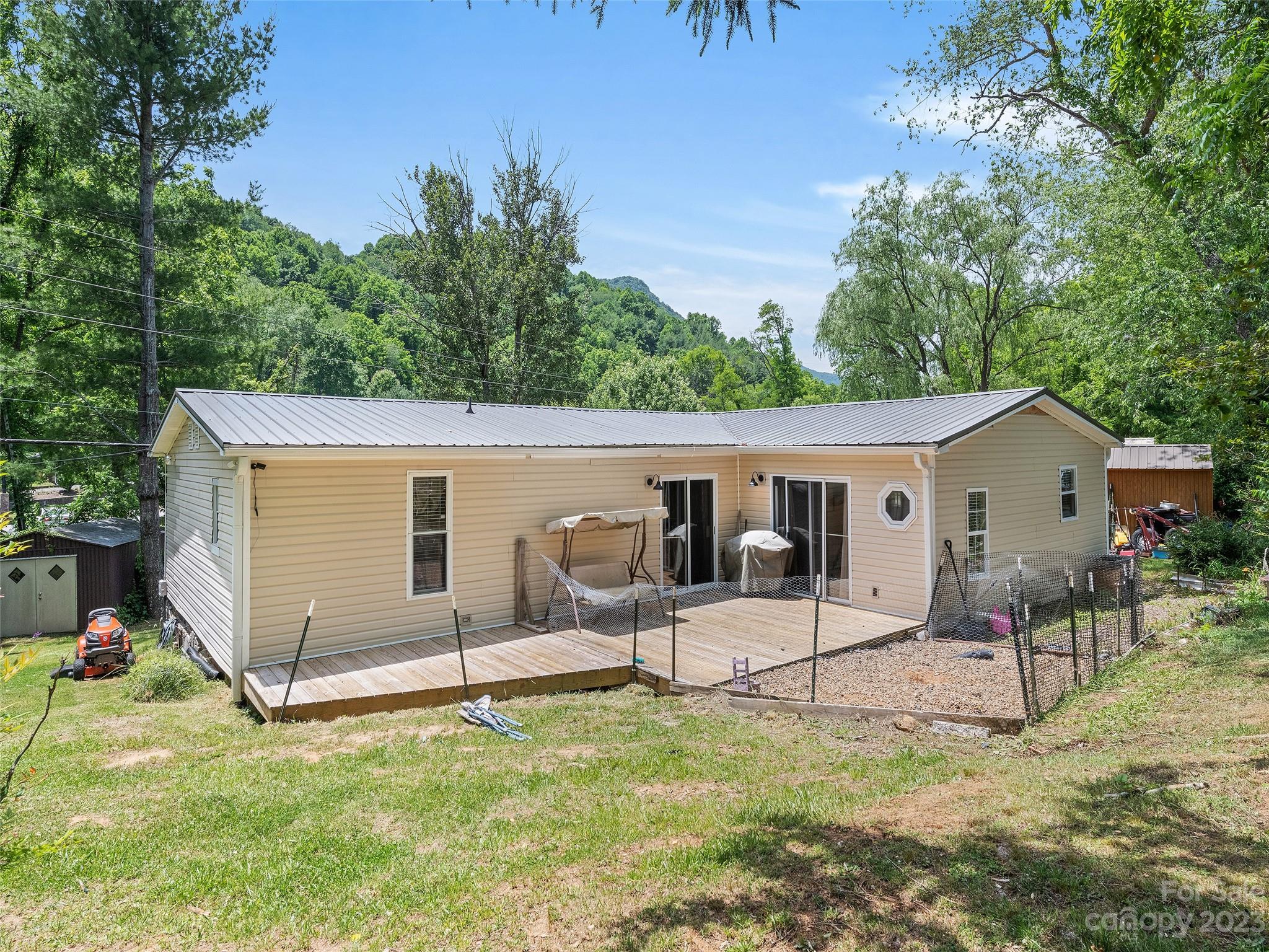 38 Happy Acres Road Waynesville, NC 28785 - Photo 6 of 28 a backyard of a house with table and chairs