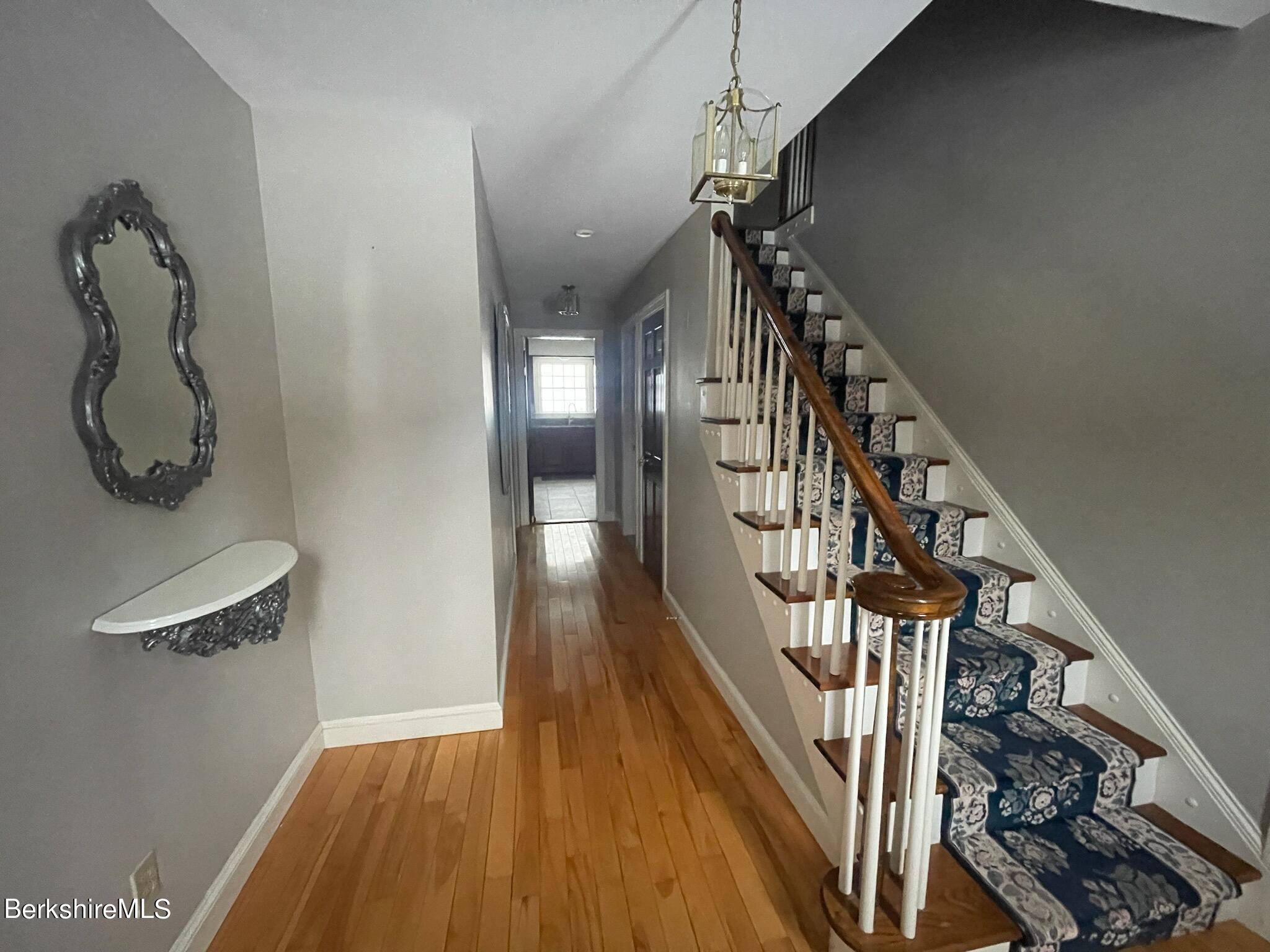 1172 Bluestone Road Bennington, VT 05201 - Photo 18 of 52 a view of a hallway with wooden floor and stairs