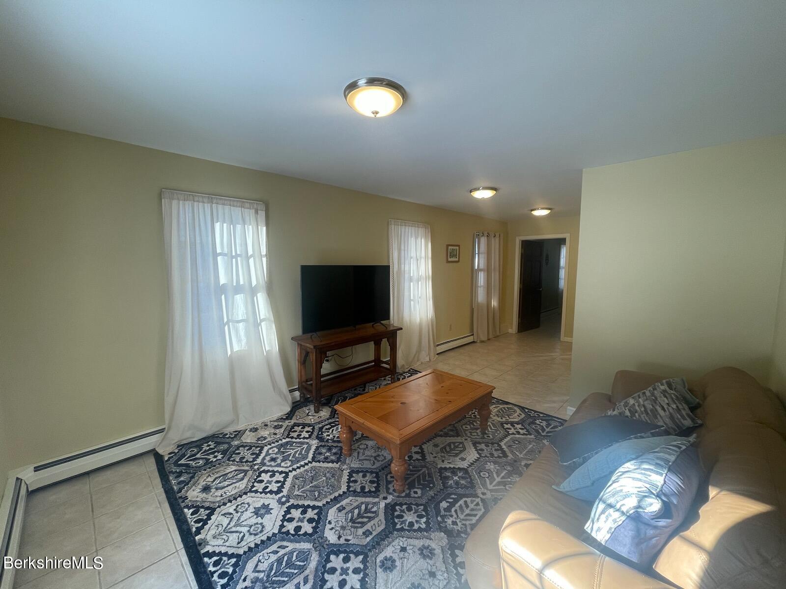 1172 Bluestone Road Bennington, VT 05201 - Photo 24 of 52 a living room with furniture and a flat screen tv