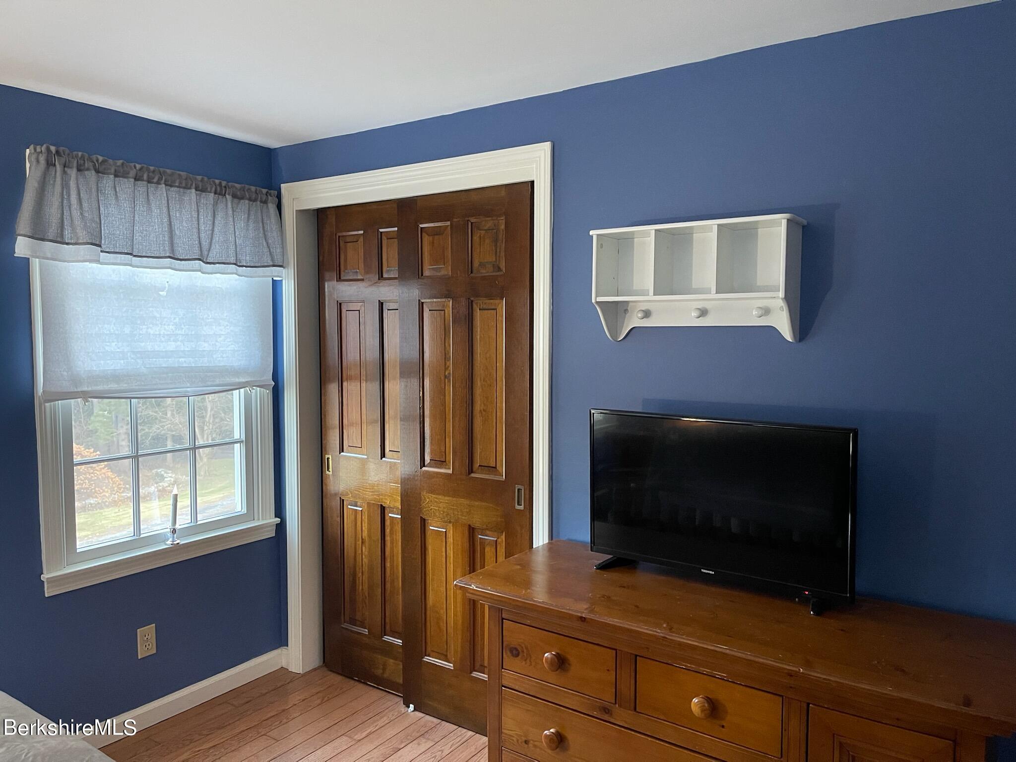1172 Bluestone Road Bennington, VT 05201 - Photo 28 of 52 a living room with furniture flat screen tv and a fireplace