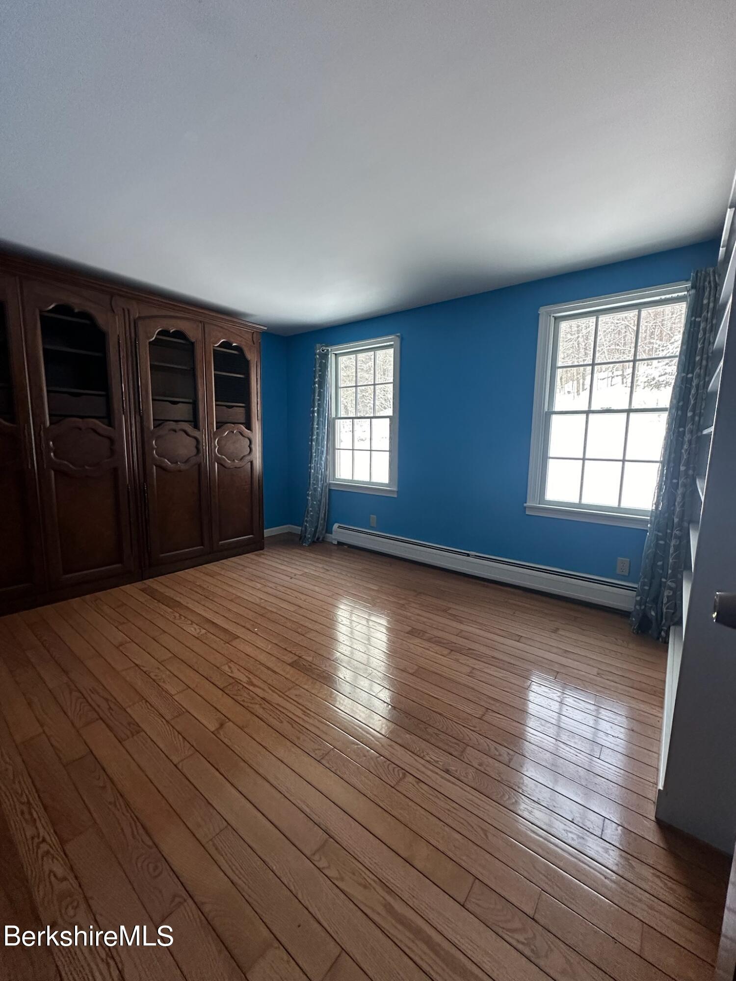 1172 Bluestone Road Bennington, VT 05201 - Photo 31 of 52 an empty room with wooden floor and windows