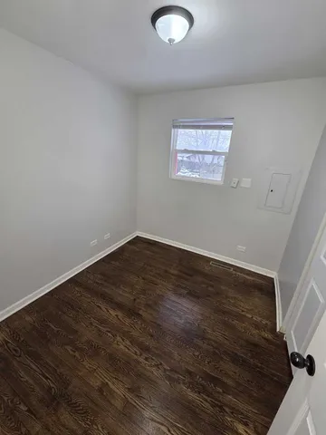 a view of a room with wooden floor and white walls