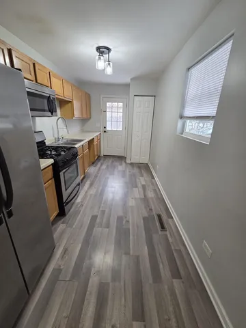 a view of kitchen with sink microwave and stove