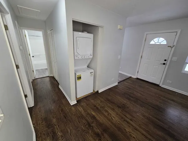 a view of a hallway with wooden floor and stairs