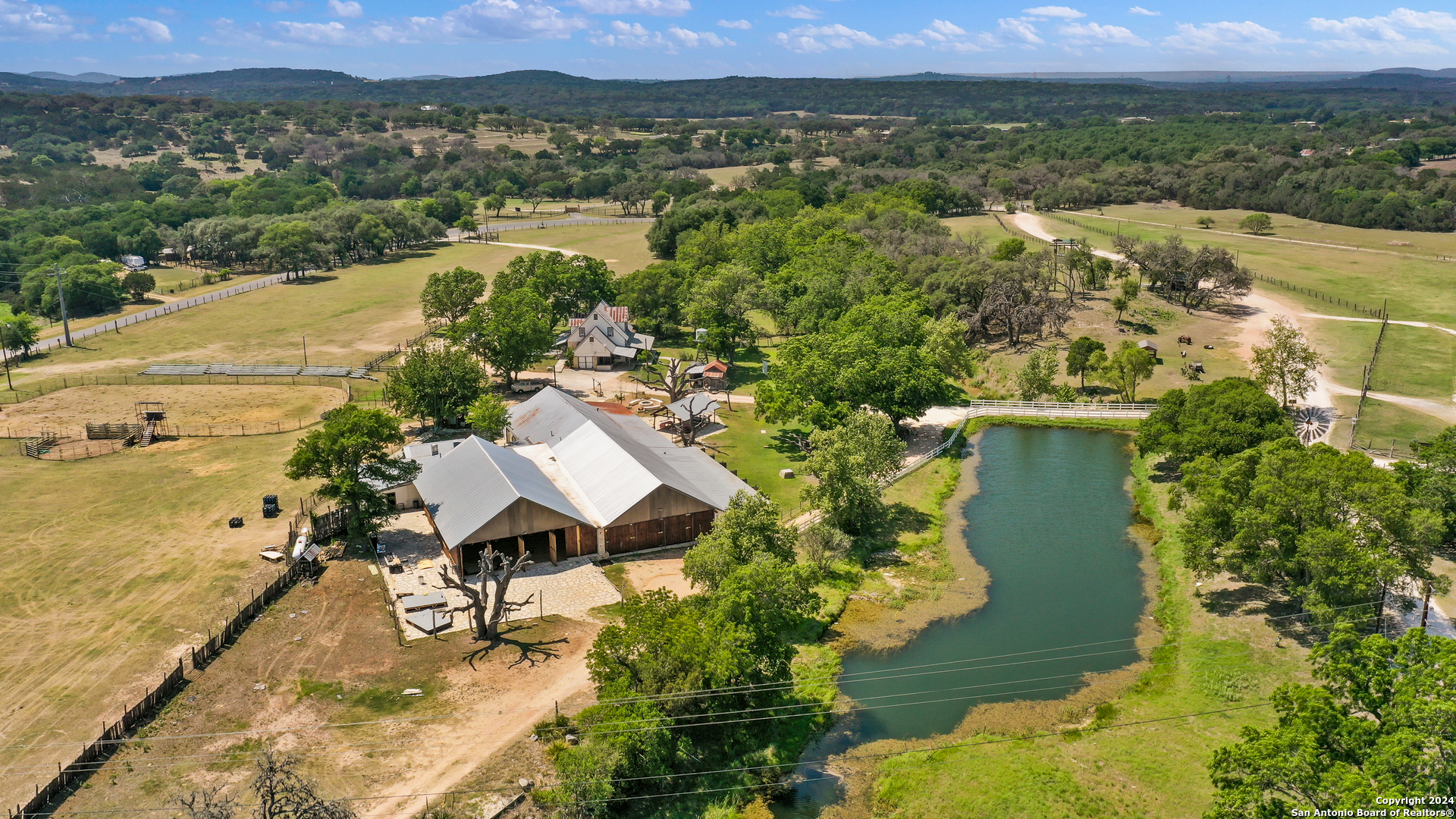 an aerial view of residential houses with outdoor space and trees