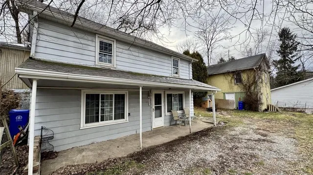 a backyard of a house with yard and outdoor seating