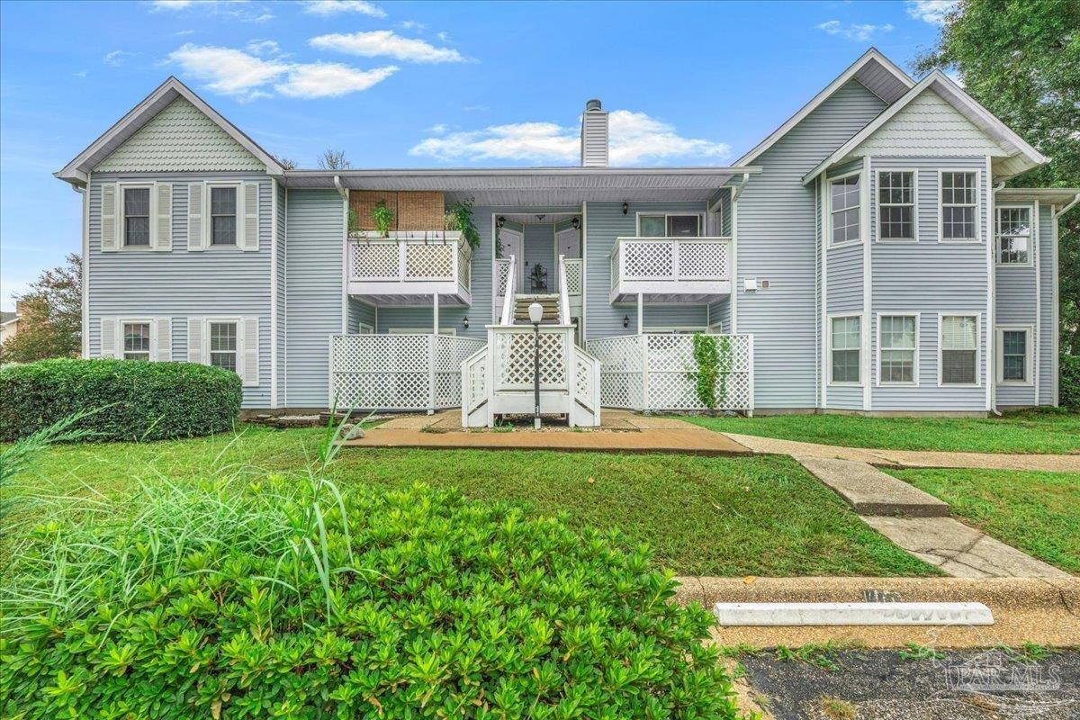 601 East Burgess Road, Unit C3 Pensacola, FL 32504 - Photo 2 of 35 a front view of a house with a yard