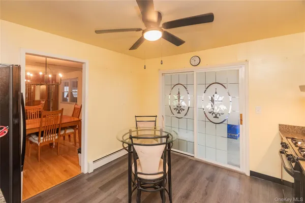 a spacious bedroom with a bed a lamp and window