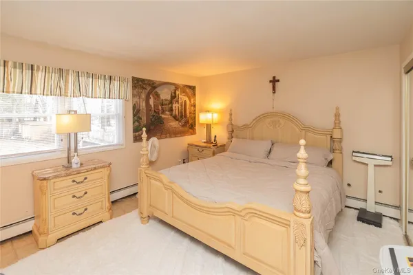 a spacious bedroom with a bed and a flat screen tv