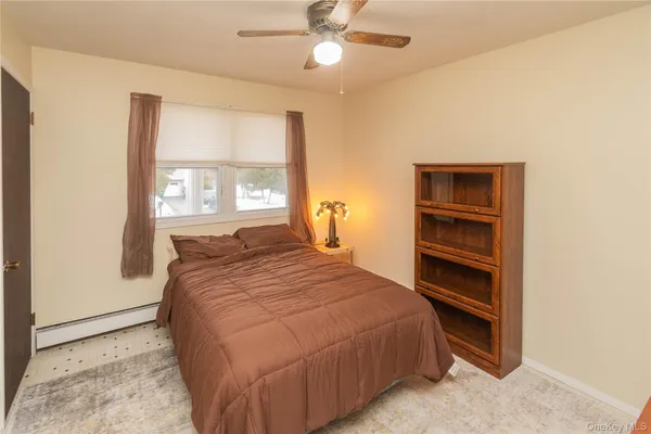 a bedroom with a bed and a ceiling fan