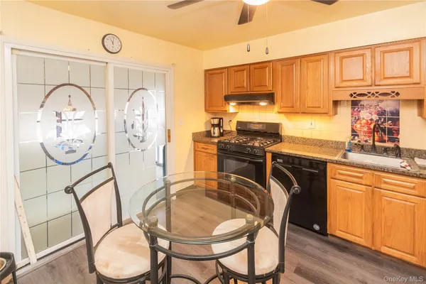 a kitchen with stainless steel appliances a stove a sink and a refrigerator