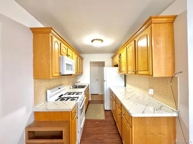 a kitchen with a stove a sink and a refrigerator