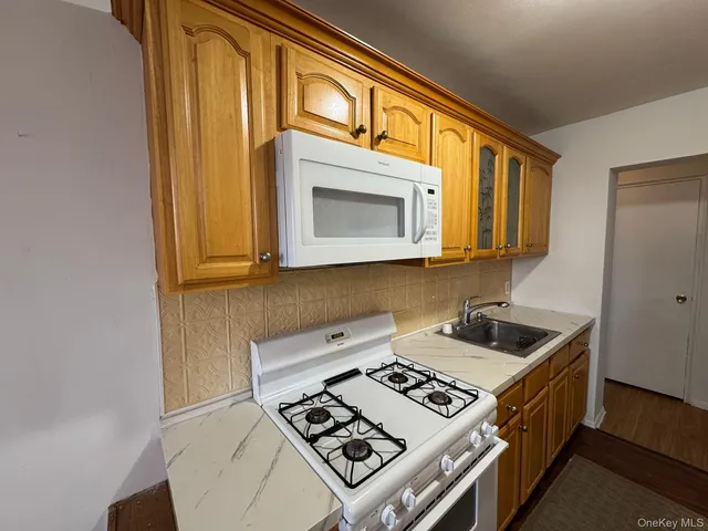 a kitchen that has a stove and a microwave oven