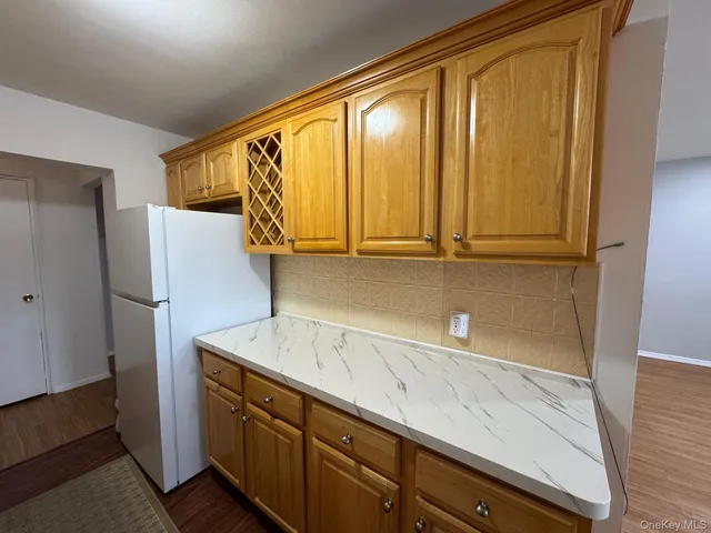 a kitchen with a refrigerator and cabinets