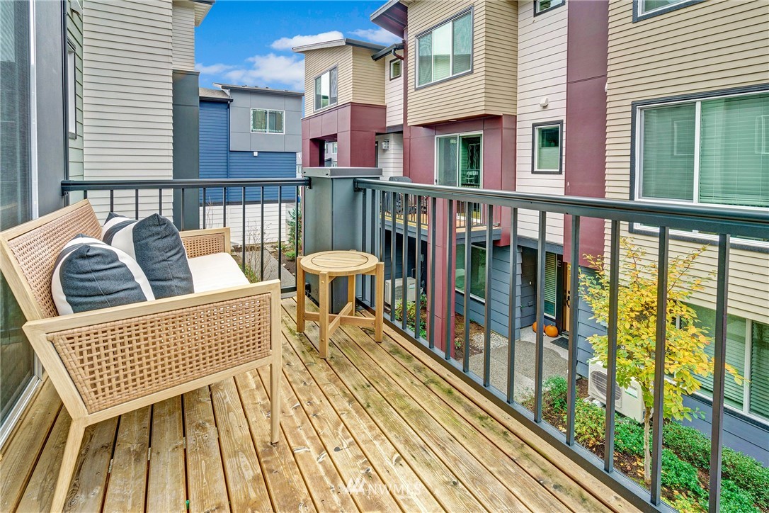 606 237th Street Southeast, Unit C Bothell, WA 98021 - Photo 12 of 27 a view of a balcony with two chairs and a wooden floor