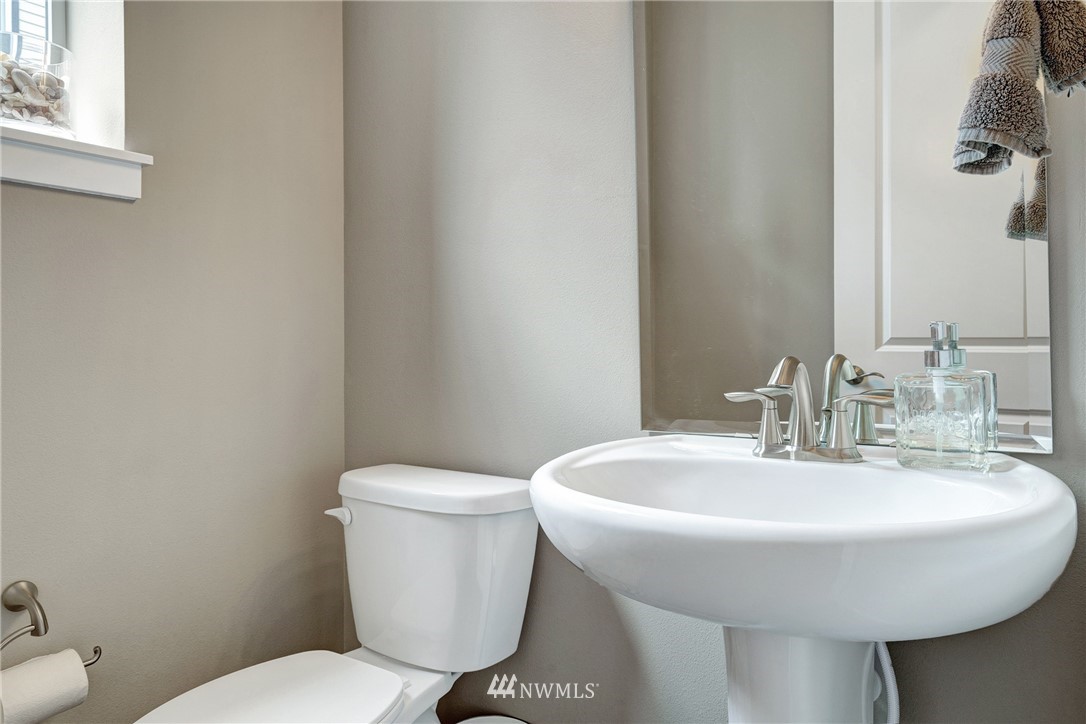 606 237th Street Southeast, Unit C Bothell, WA 98021 - Photo 13 of 27 a bathroom with a toilet a sink and a mirror