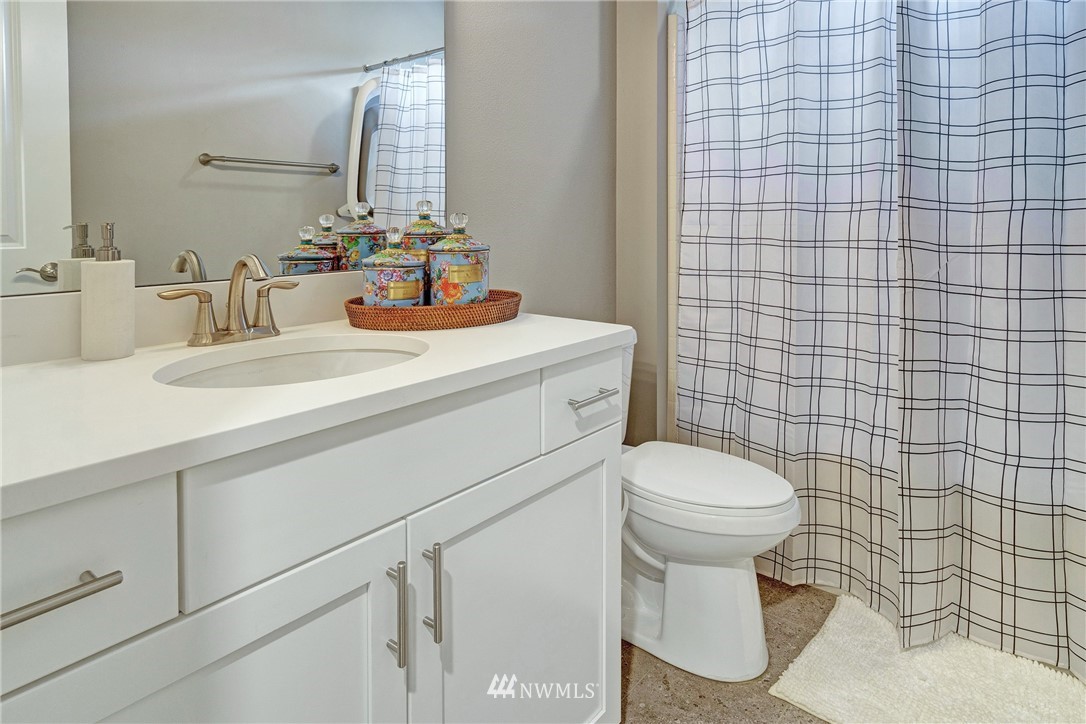 606 237th Street Southeast, Unit C Bothell, WA 98021 - Photo 20 of 27 a bathroom with a sink a toilet and a mirror