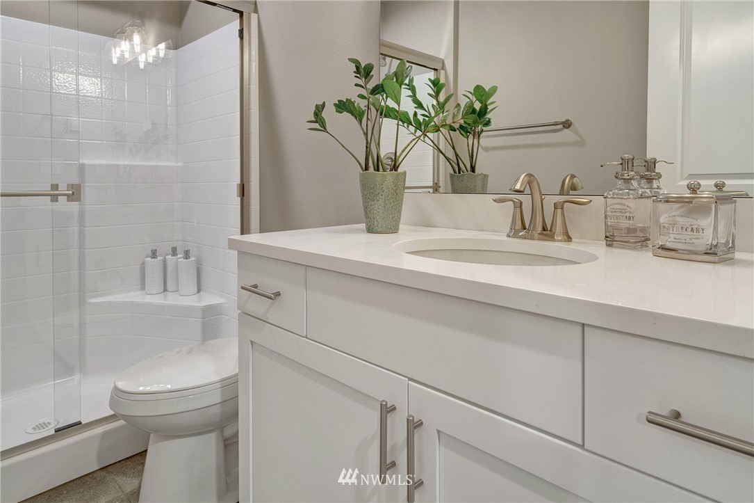 606 237th Street Southeast, Unit C Bothell, WA 98021 - Photo 4 of 27 a bathroom with a sink a toilet and shower