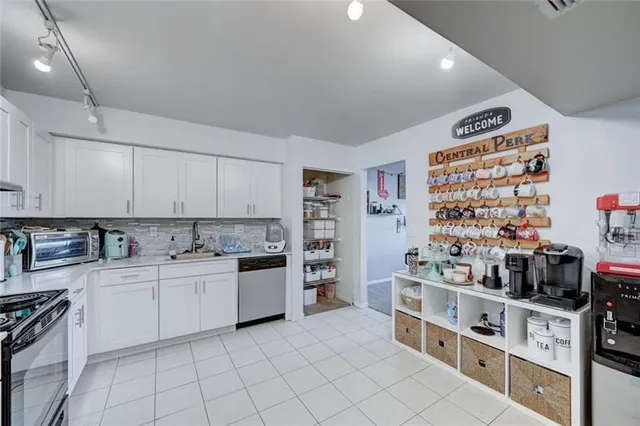 a kitchen with stainless steel appliances a sink and counter top space