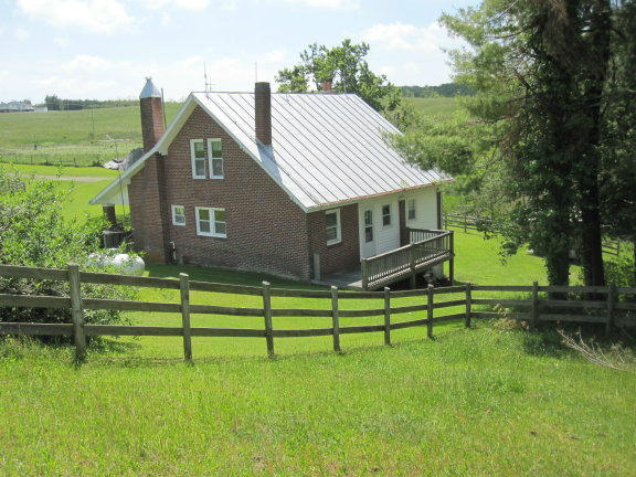 3404 Black Ridge Road Southwest Floyd, VA 24091 - Photo 6 of 39 a front view of a house with a yard table and chairs