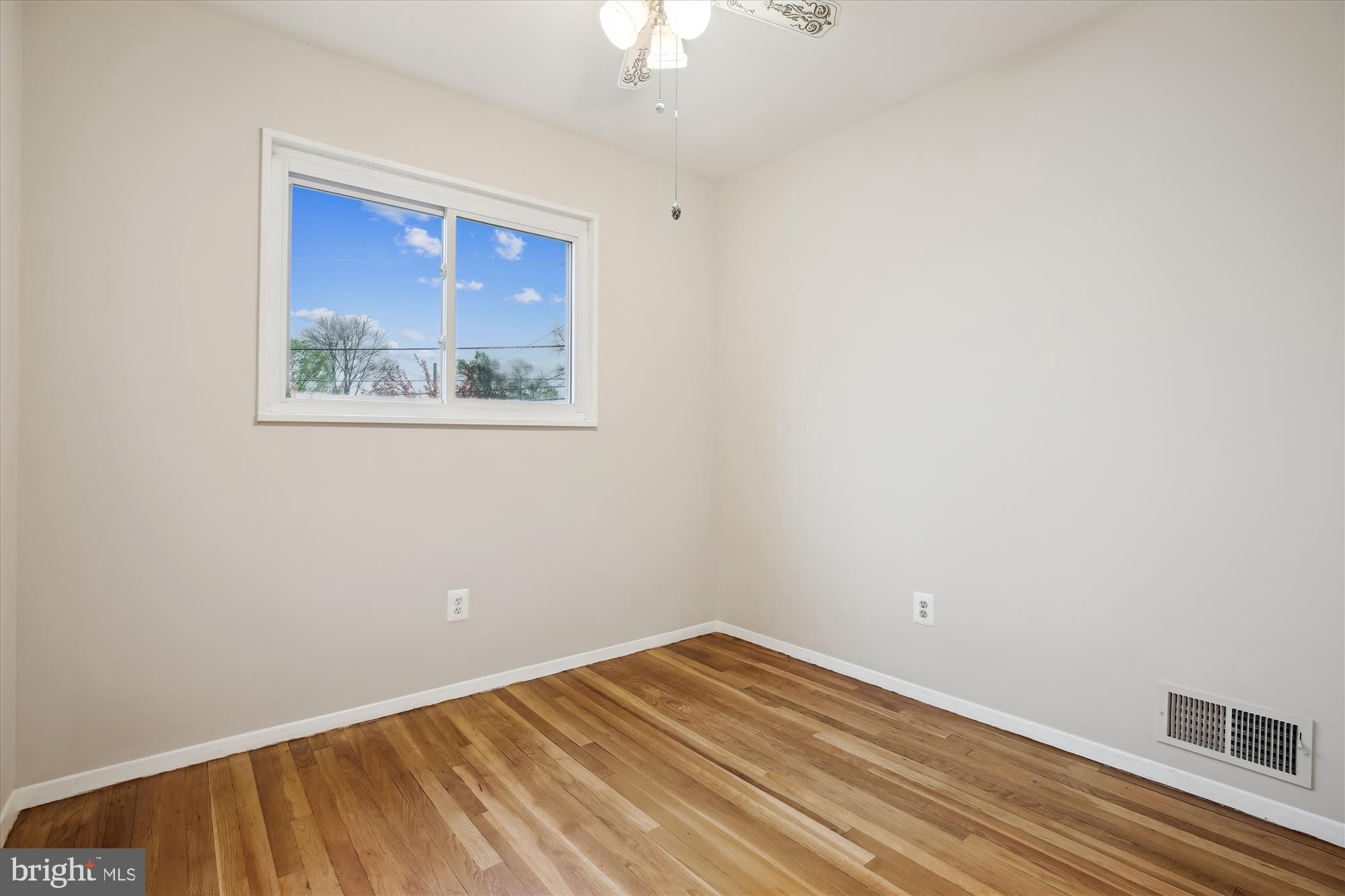 4105 Tulare Drive Silver Spring, MD 20906 - Photo 21 of 54 a view of empty room with window and wooden floor