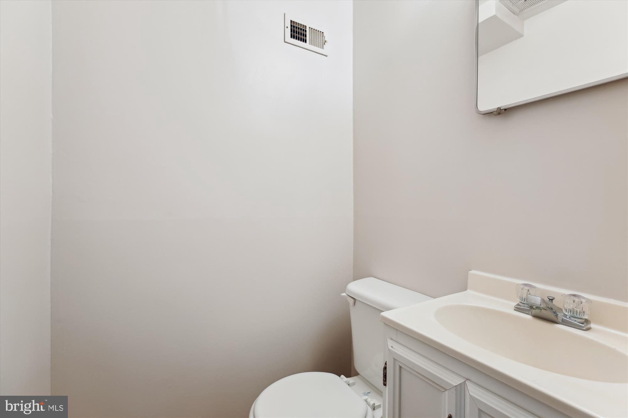 4105 Tulare Drive Silver Spring, MD 20906 - Photo 25 of 54 a bathroom with a sink vanity mirror and toilet