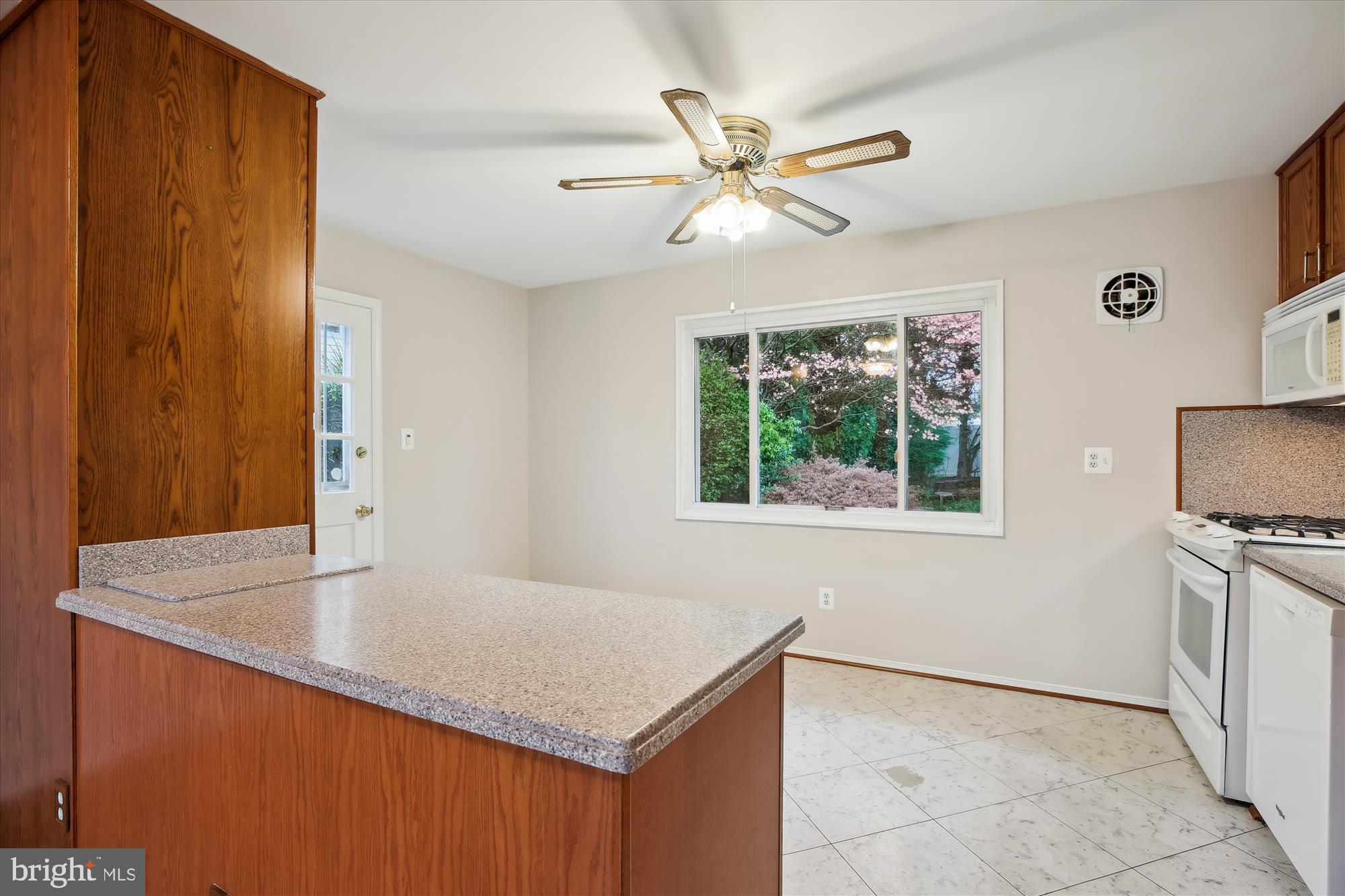 4105 Tulare Drive Silver Spring, MD 20906 - Photo 6 of 54 a kitchen with kitchen island a counter top space and a window