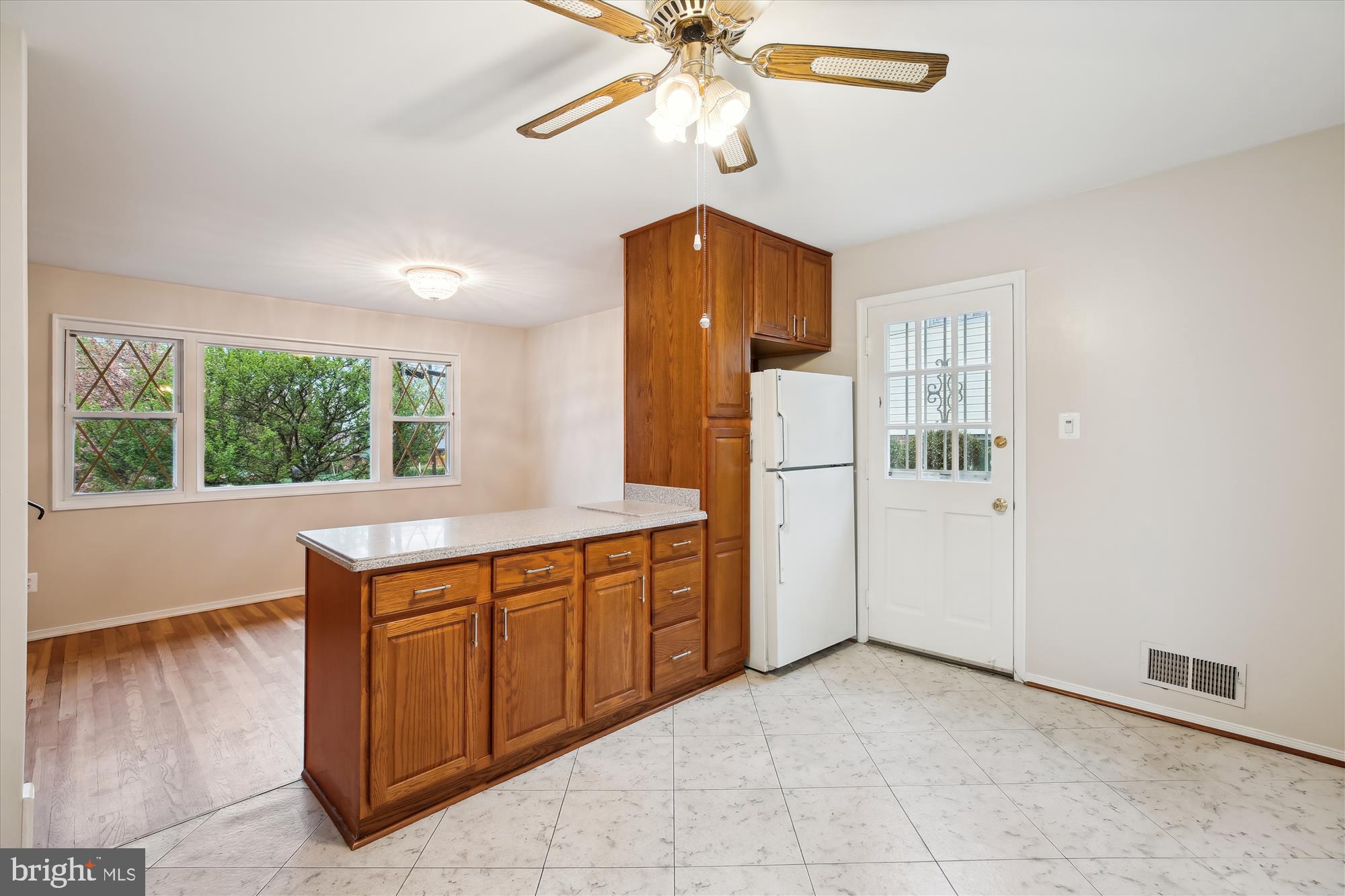 4105 Tulare Drive Silver Spring, MD 20906 - Photo 7 of 54 a kitchen with stainless steel appliances a sink cabinets and wooden floor