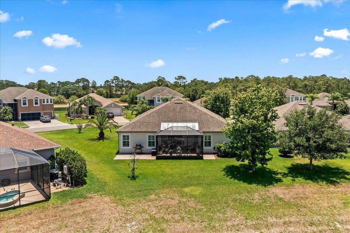 337 Abernathy Circle Palm Bay, FL 32909 - Photo 20 of 51 a view of a garden with a bench under an umbrella