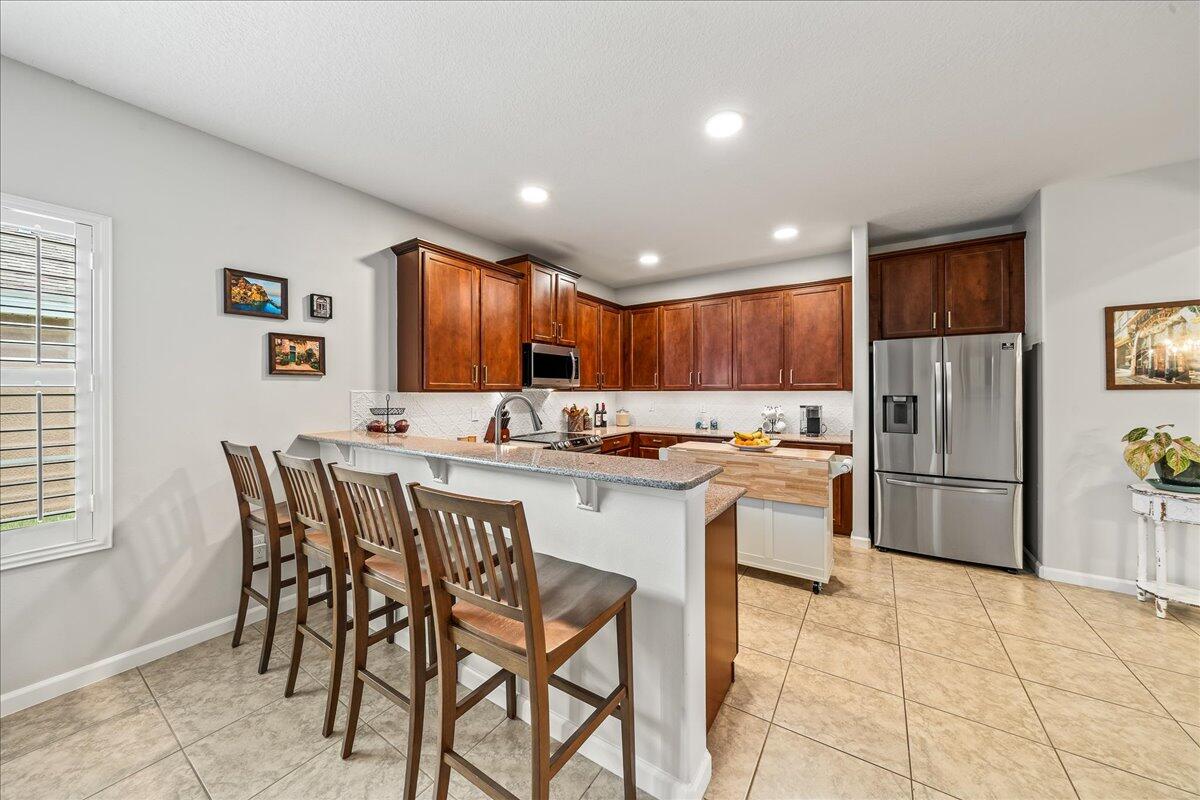337 Abernathy Circle Palm Bay, FL 32909 - Photo 22 of 51 a kitchen with stainless steel appliances granite countertop a refrigerator and a stove top oven