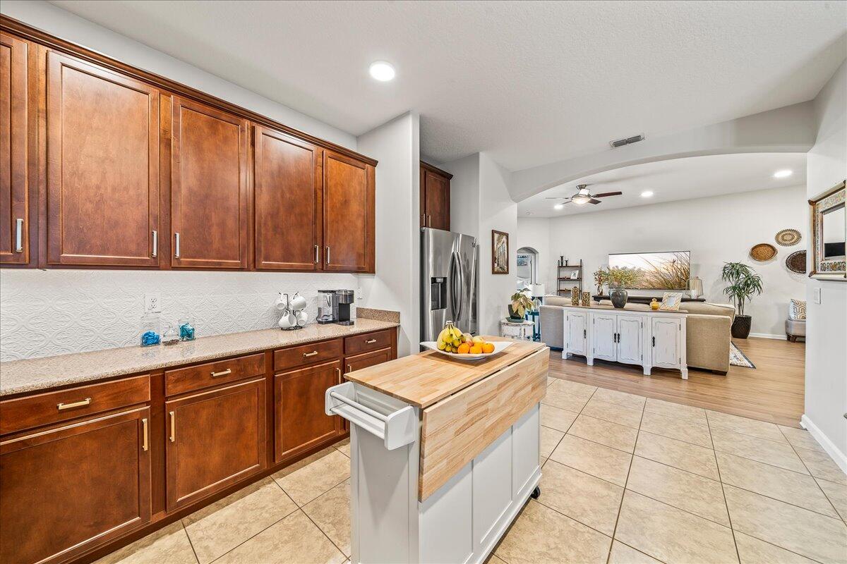 337 Abernathy Circle Palm Bay, FL 32909 - Photo 23 of 51 a large white kitchen with a stove a sink dishwasher and a refrigerator with wooden floor