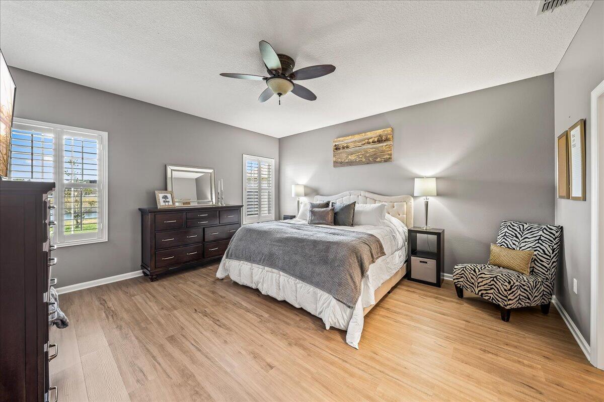 337 Abernathy Circle Palm Bay, FL 32909 - Photo 27 of 51 a bedroom with a bed and wooden floor