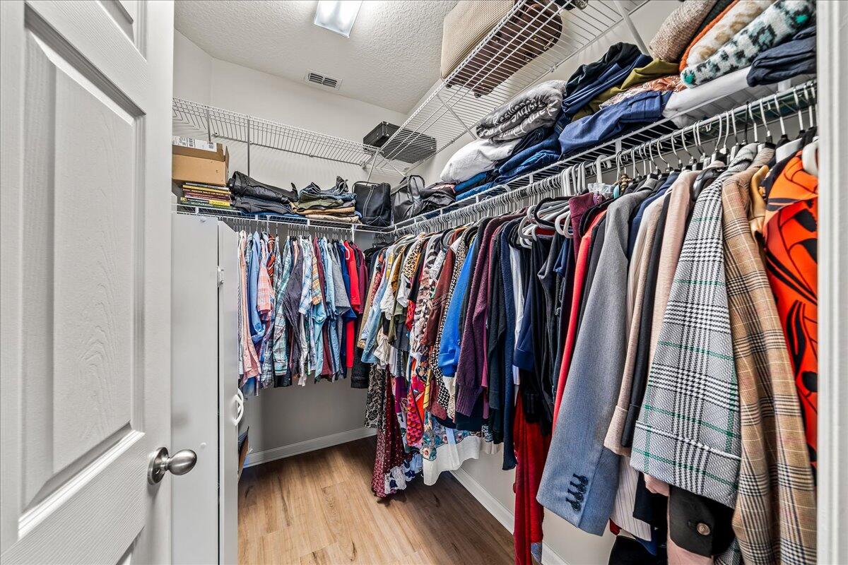 337 Abernathy Circle Palm Bay, FL 32909 - Photo 31 of 51 a view of walk in closet with clothes