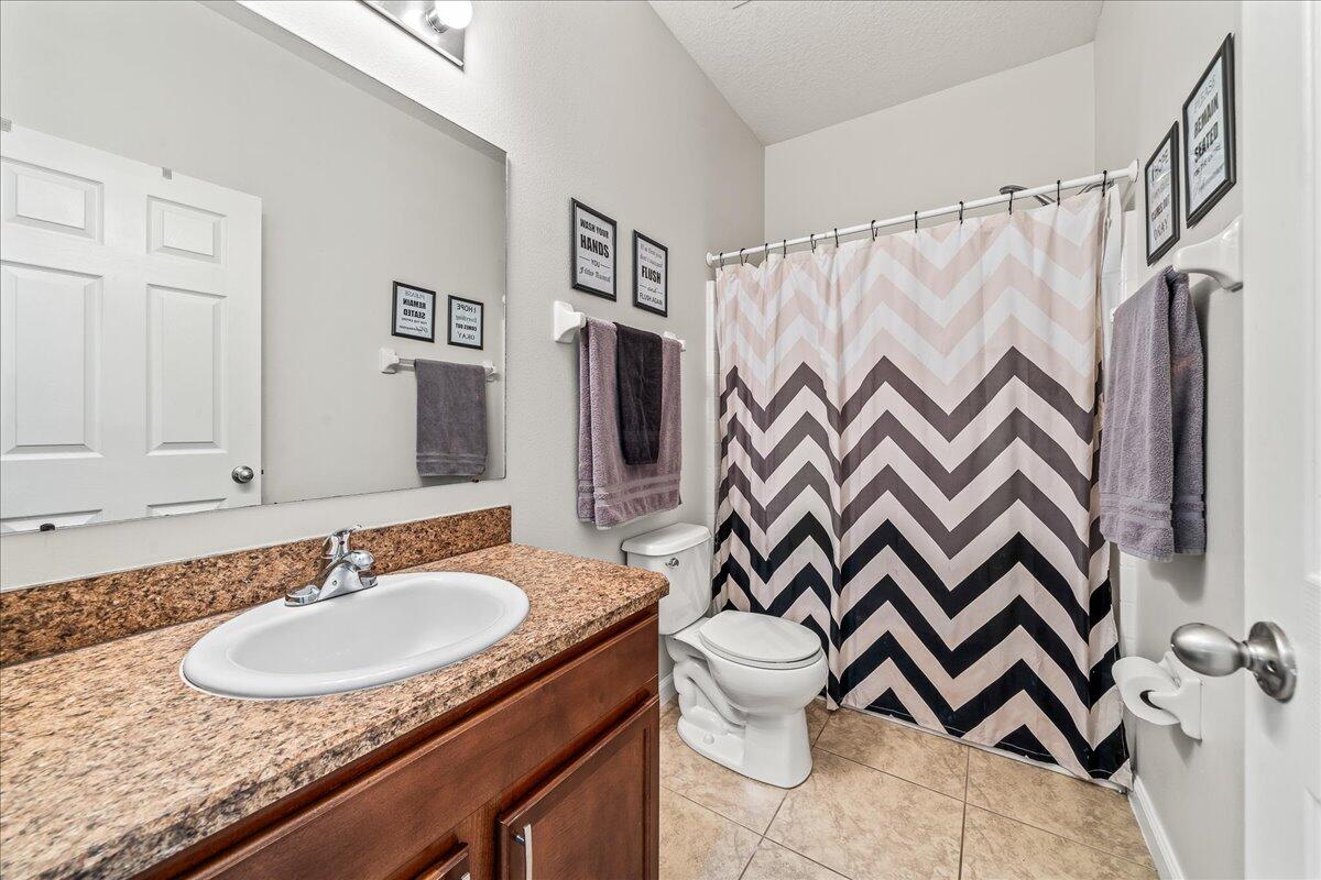337 Abernathy Circle Palm Bay, FL 32909 - Photo 34 of 51 a bathroom with a sink toilet a mirror and shower curtain