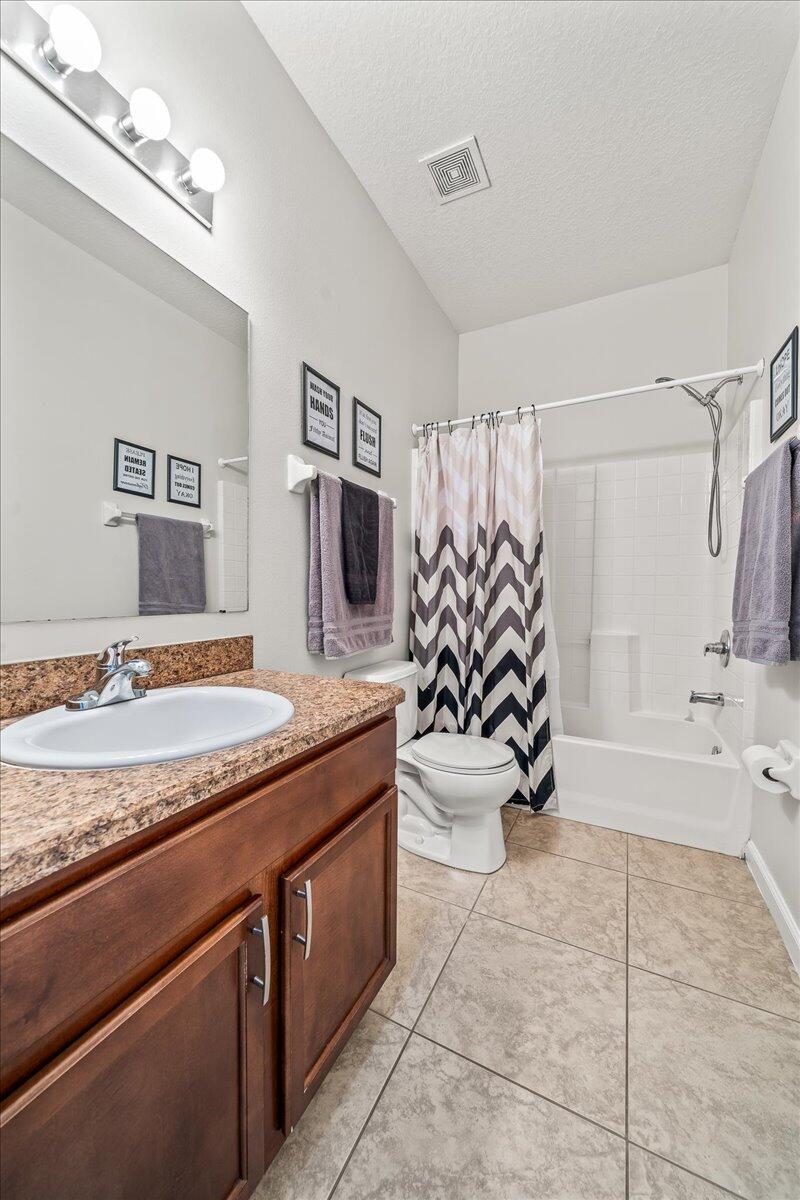 337 Abernathy Circle Palm Bay, FL 32909 - Photo 35 of 51 a spacious bathroom with a granite countertop sink a toilet and bathtub