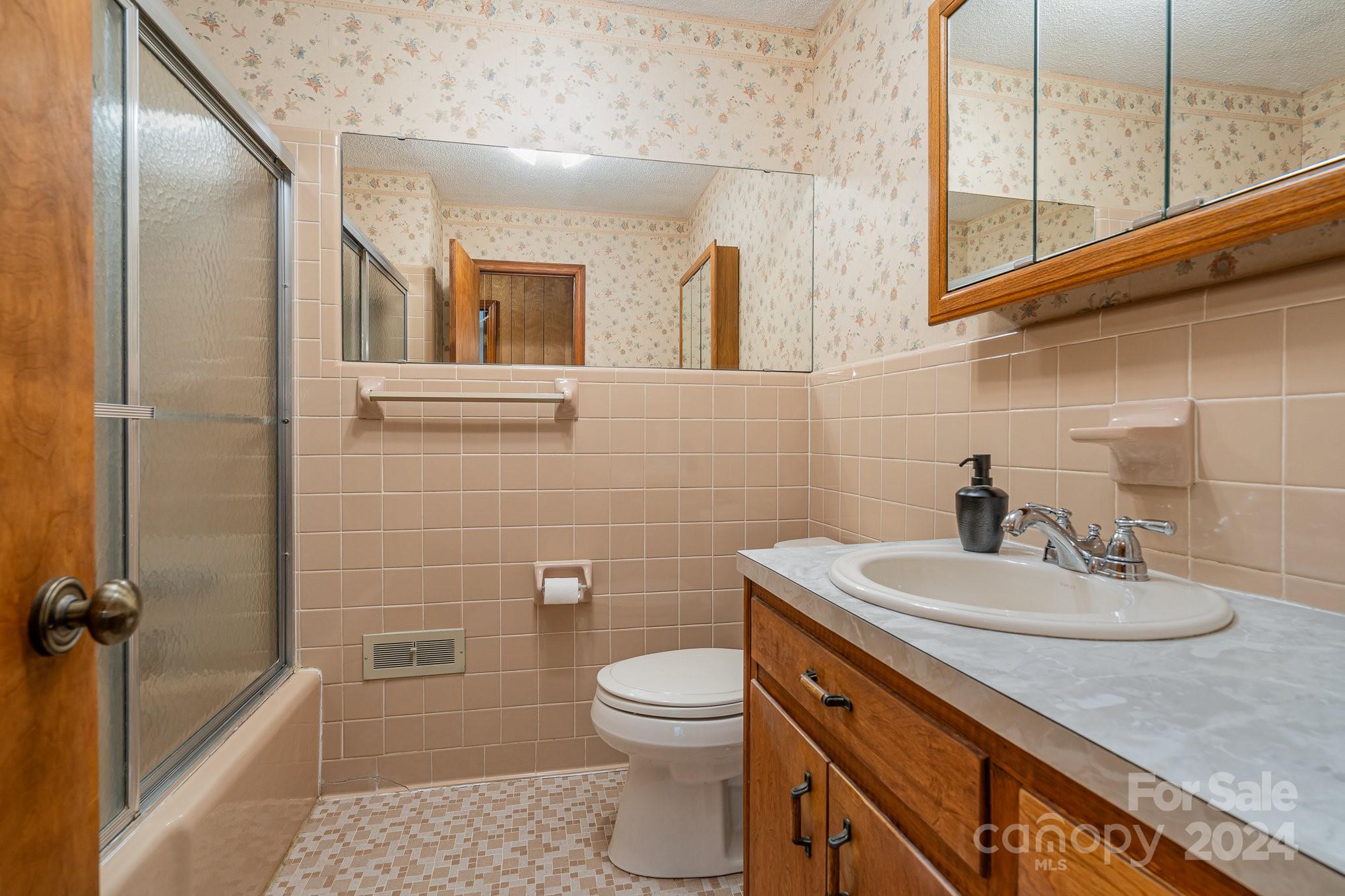 5124 Margaret Wallace Road Matthews, NC 28105 - Photo 14 of 26 a bathroom with a sink a toilet and mirror