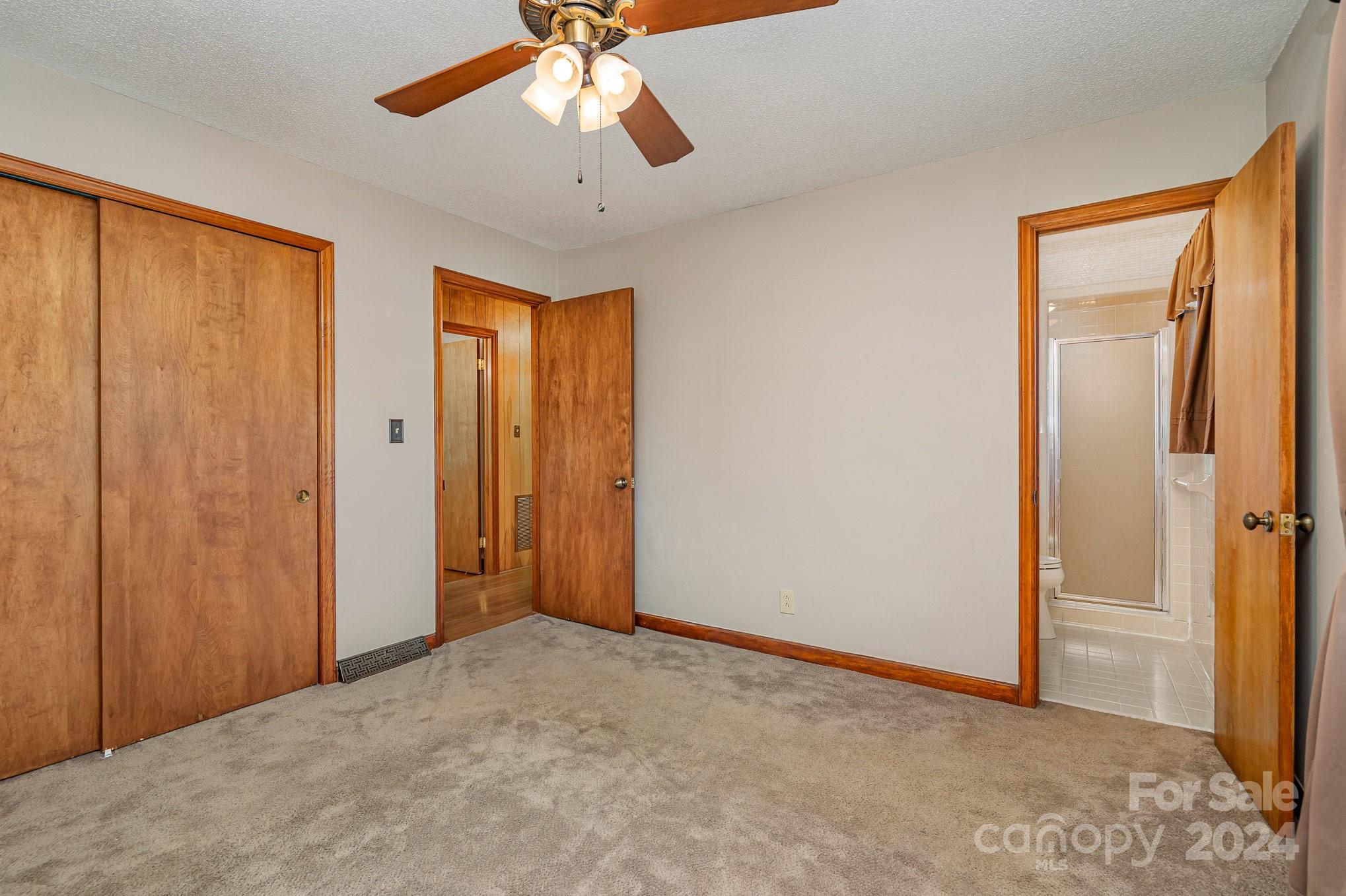 5124 Margaret Wallace Road Matthews, NC 28105 - Photo 16 of 26 an empty room with closet and a chandelier fan