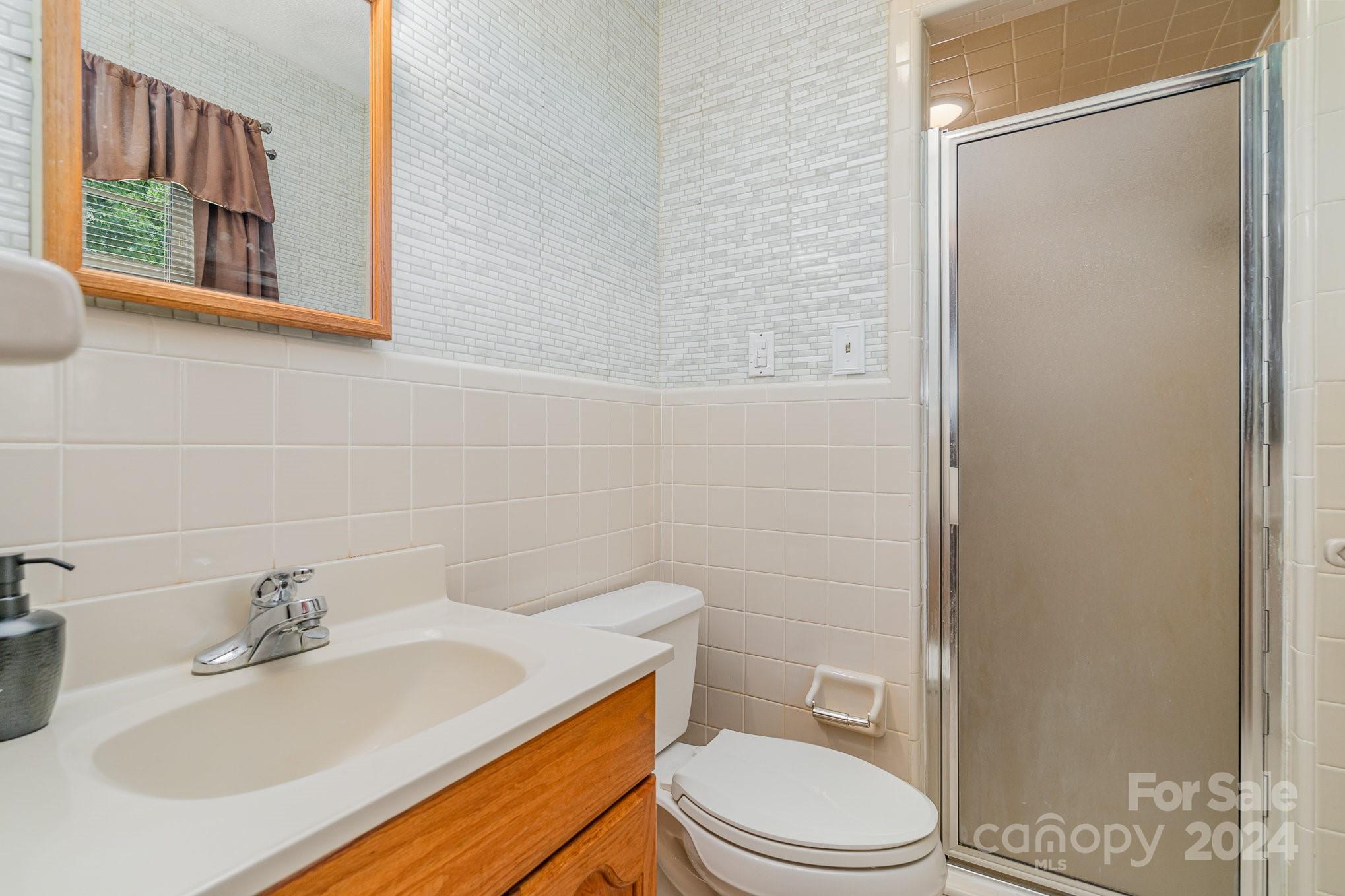 5124 Margaret Wallace Road Matthews, NC 28105 - Photo 18 of 26 a bathroom with a sink toilet and mirror