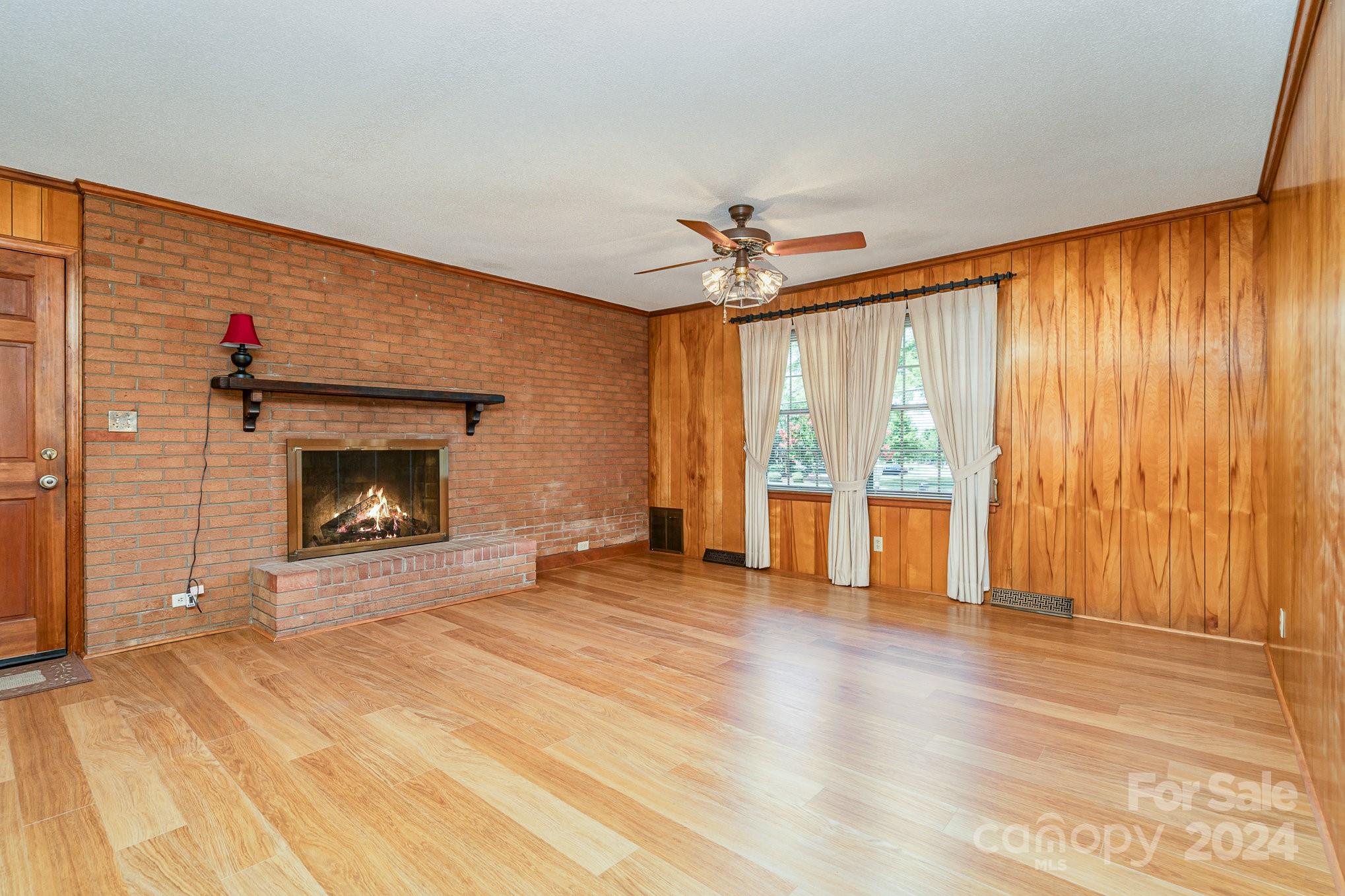 5124 Margaret Wallace Road Matthews, NC 28105 - Photo 6 of 26 a view of an empty room with a fireplace and a window