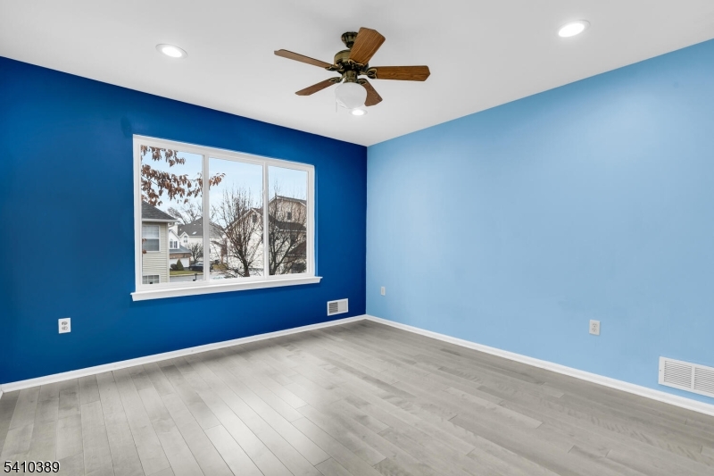 450 Vanderveer Road Bridgewater, NJ 08807 - Photo 25 of 44 a view of a big room with wooden floor and a ceiling fan