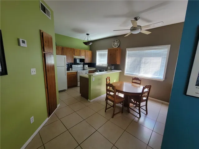 a dining room with furniture and window