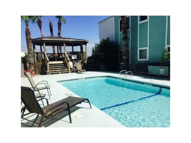 a balcony with table and chairs
