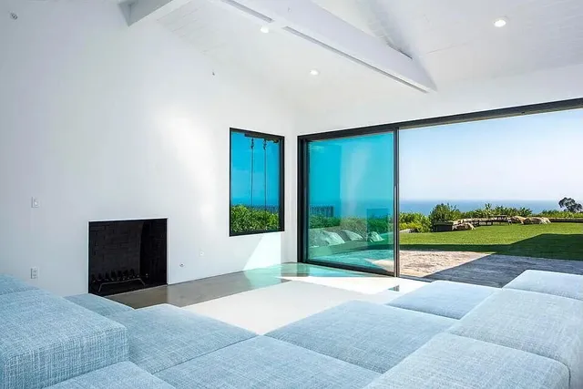 a view of a room with a flat screen tv and a garden