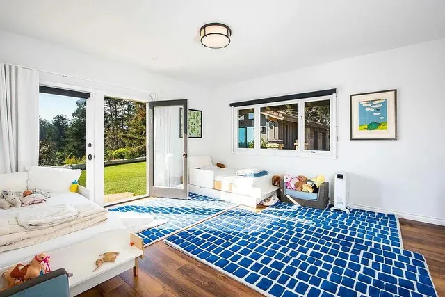 a bedroom with furniture and a window