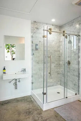 a bathroom with a shower and a sink