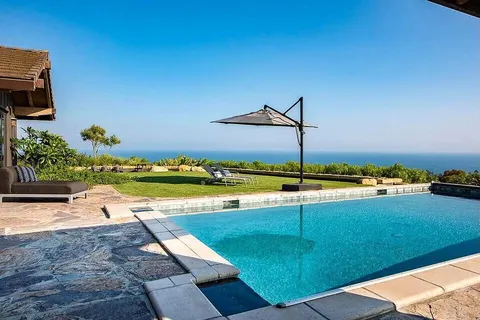 a view of a swimming pool with an outdoor seating